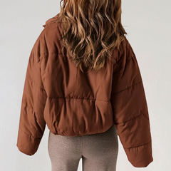 Willa Emma high collar puffer jacket for women by Christine Brewer, featuring a cozy, insulated design and stylish high neckline.