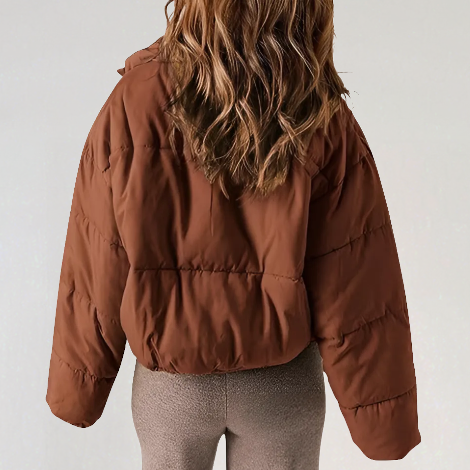Willa Emma high collar puffer jacket for women by Christine Brewer, featuring a cozy, insulated design and stylish high neckline.