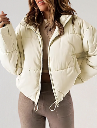 Beige Emma high collar puffer jacket for women by Christine Brewer, showcasing the stylish, insulated design and high collar detail.