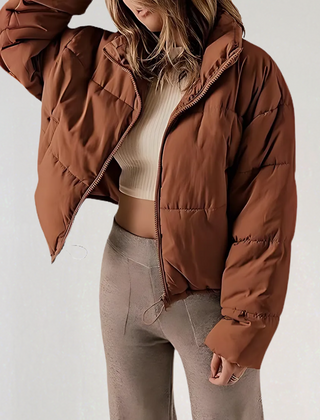 Brown Emma high collar puffer jacket for women by Christine Brewer, showcasing a cozy, insulated winter jacket with a high collar.