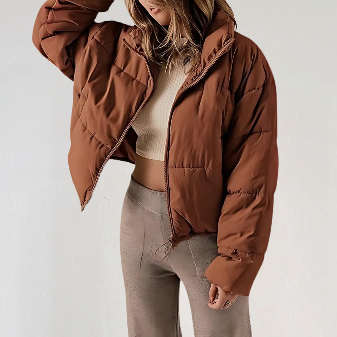 Brown Emma high collar puffer jacket for women by Christine Brewer, showcasing a cozy, insulated winter jacket with a high collar.