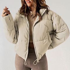 Khaki Emma high collar puffer jacket for women by Christine Brewer, featuring a stylish warm winter jacket with a high-neck design.