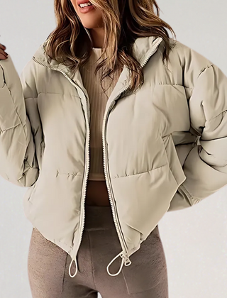 Khaki Emma high collar puffer jacket for women by Christine Brewer, featuring a stylish warm winter jacket with a high-neck design.