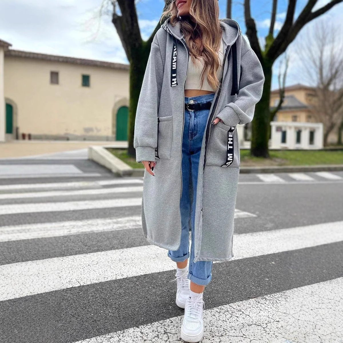 Women wearing the Christine Brewer Isla oversized hooded long coat with zip-up fleece outerwear, showcasing its relaxed fit and cozy design.