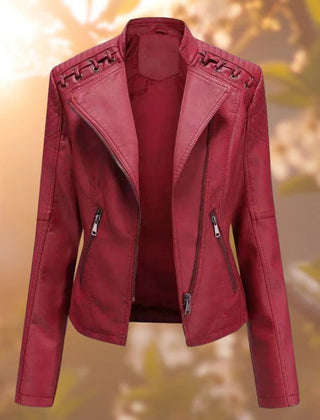 Women's biker-style zip-up faux leather jacket by Christine Brewer, showcasing a sleek black design and front zipper detail.
