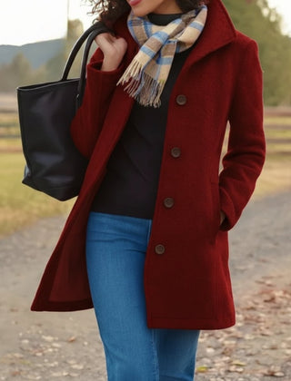 Women's classic mid-length button-up coat by Christine Brewer, shown in a stylish, tailored design with front buttons and long sleeves.