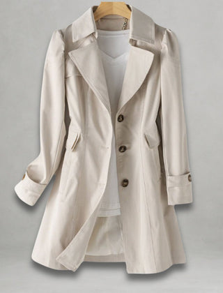Women’s classic fit single-breasted trench coat with notch lapel by Christine Brewer, shown in a neutral color on a model.