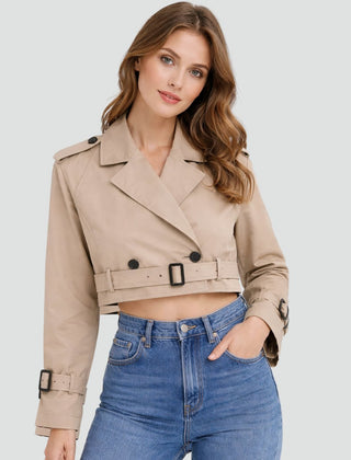 Women's cropped double-breasted belted trench coat by Christine Brewer, shown in a stylish beige with lapel collar and waist belt.