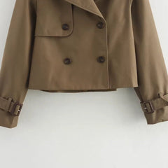 Olivia women's cropped double-breasted trench coat by Christine Brewer featuring buckle cuffs and classic trench styling.