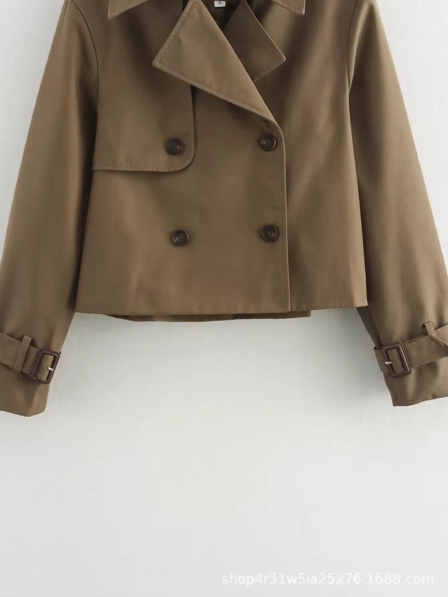 Olivia women's cropped double-breasted trench coat by Christine Brewer featuring buckle cuffs and classic trench styling.