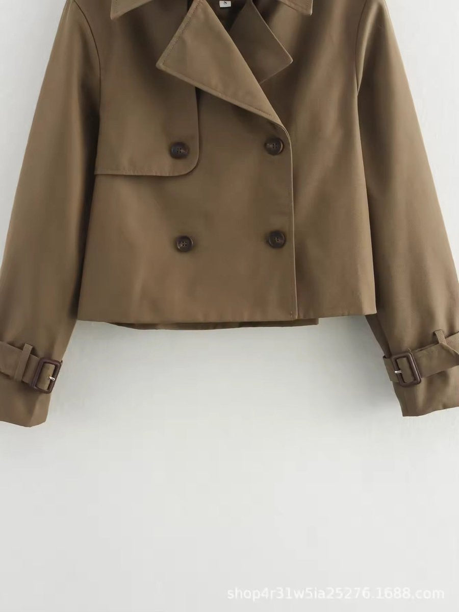 Olivia women's cropped double-breasted trench coat by Christine Brewer featuring buckle cuffs and classic trench styling.