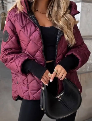 Women's diamond quilted hooded puffer jacket by Christine Brewer, featuring a zip-up design and cozy padded insulation.