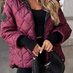 Women's Sienna diamond quilted zip-up hooded puffer jacket by Christine Brewer, showcasing its stylish quilted design and hood.