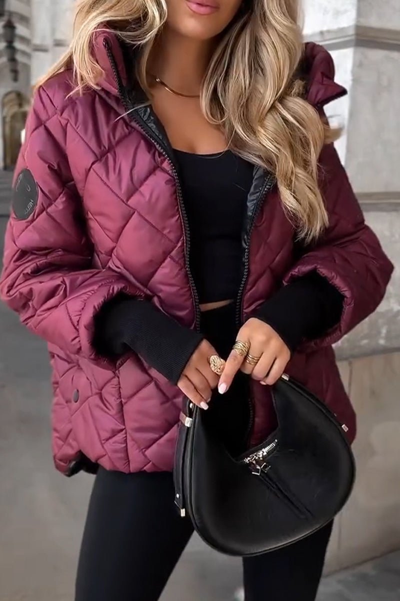 Women's Sienna diamond quilted zip-up hooded puffer jacket by Christine Brewer, showcasing its stylish quilted design and hood.