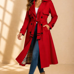 Emily women's double-breasted belted long trench coat by Christine Brewer, shown on a model with classic beige fabric and waist belt.