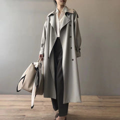 Women's double-breasted water-repellent long trench coat by Christine Brewer, shown in a stylish, weatherproof design.