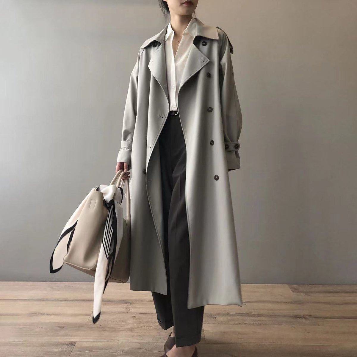 Women's double-breasted water-repellent long trench coat by Christine Brewer, shown in a stylish, weatherproof design.
