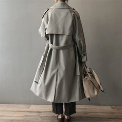 Women's double-breasted water-repellent long trench coat by Christine Brewer, shown in a stylish, water-resistant exterior.