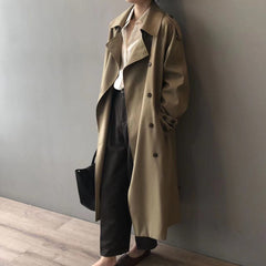 Women's double-breasted water-repellent long trench coat by Christine Brewer, shown in a stylish, tailored fit with a belt and classic collar.