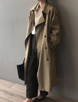 Women's double-breasted water-repellent long trench coat by Christine Brewer, shown in a stylish, tailored fit with a belt and classic collar.