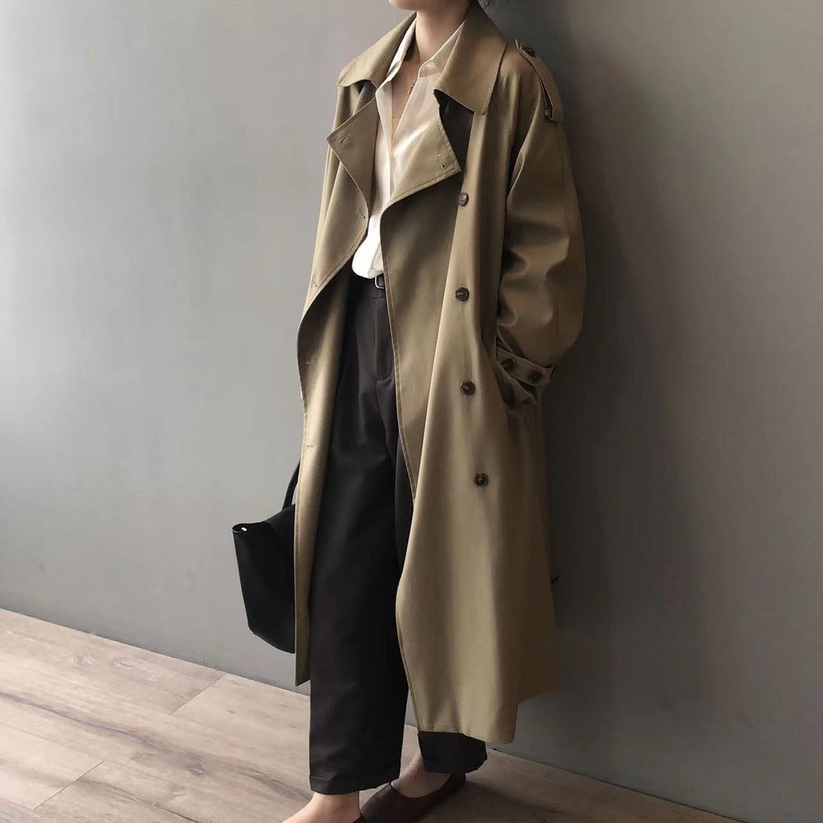 Eleanor women's double-breasted water-repellent long trench coat by Christine Brewer, shown in black with wide lapels and belt detail.