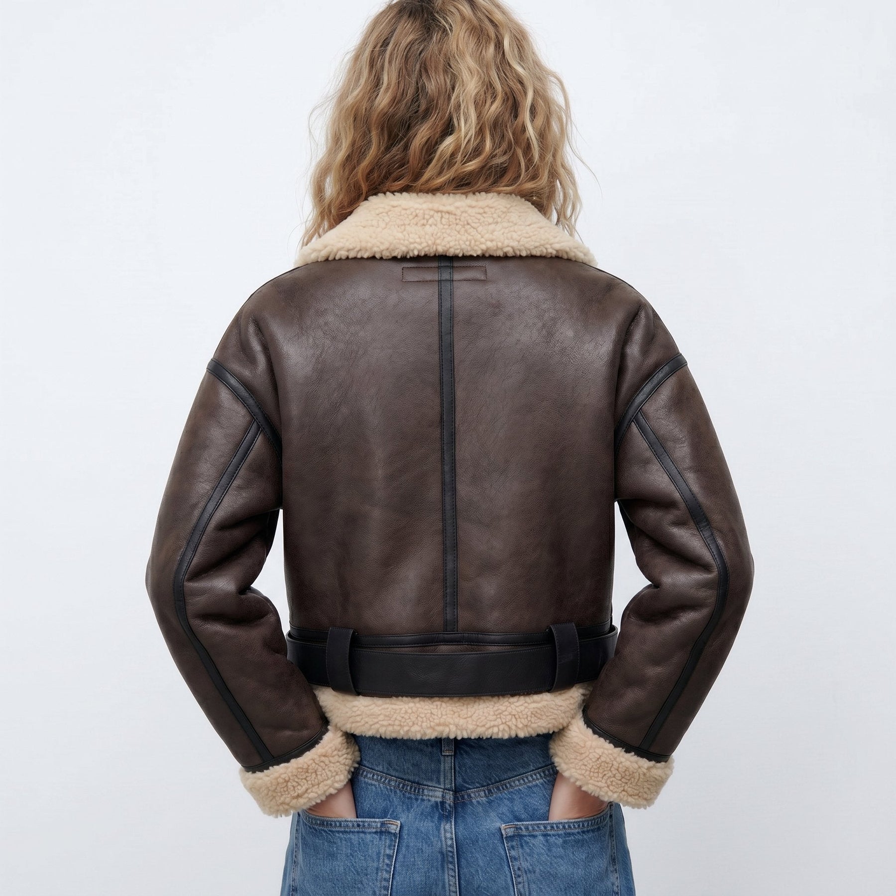 Women's double-sided shearling bomber jacket by Christine Brewer, featuring plush shearling exterior and cozy interior.