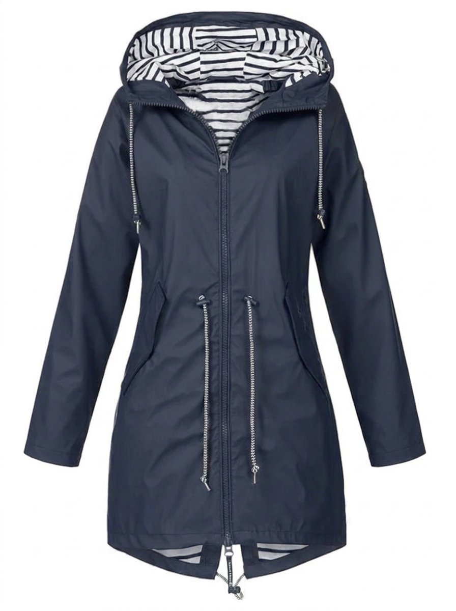 Victoria women's waterproof hooded rain coat with drawstring, by Christine Brewer, shown in a stylish outdoor setting.