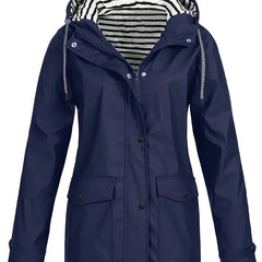 Women's waterproof rain coat with hood, striped lining, and zip-up closure by Christine Brewer, suitable for rainy weather.