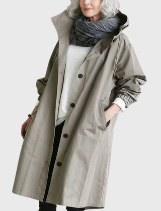 Elegant Ella women's hooded water-repellent oversized long trench coat by Christine Brewer displayed on a model outdoors.