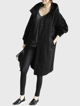 Women’s hooded water-repellent oversized long trench coat by Christine Brewer, shown in a stylish, long silhouette with a hood.