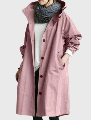 Woman wearing Christine Brewer Ella hooded water-repellent oversized long trench coat, showing the hood and stylish silhouette.