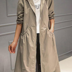 Women’s waterproof long trench coat with hood and zip-up front by Christine Brewer, designed for rain protection and stylish layering.