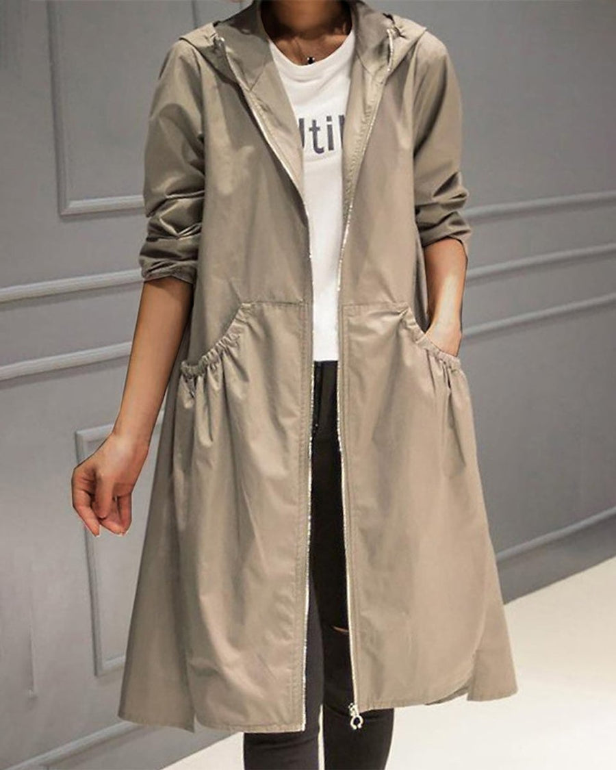 Women’s waterproof long trench coat with hood and zip-up front by Christine Brewer, designed for rain protection and stylish layering.