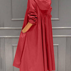Women's waterproof long trench coat by Christine Brewer with hood and zip-up front, designed for rain protection and style.