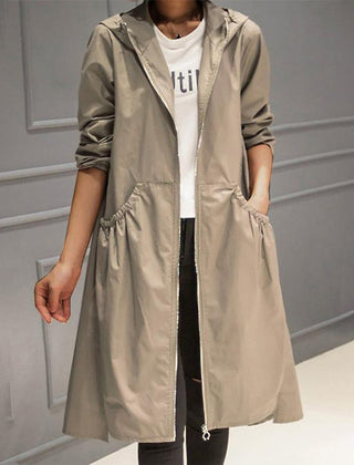 Women’s hooded waterproof longline trench coat by Christine Brewer, shown in a stylish, rain-resistant design with a hood and tailored fit.