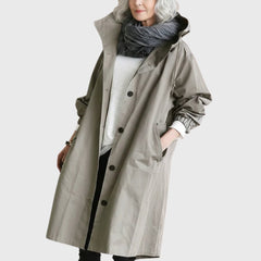 Women's waterproof hooded long trench coat by Christine Brewer, relaxed fit, perfect for rainy weather and casual outdoor wear.