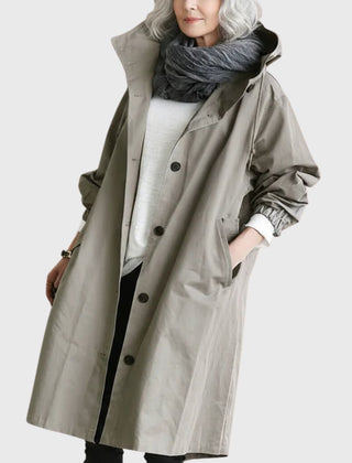 Women's waterproof hooded long trench coat by Christine Brewer, relaxed fit, perfect for rainy weather and casual outdoor wear.