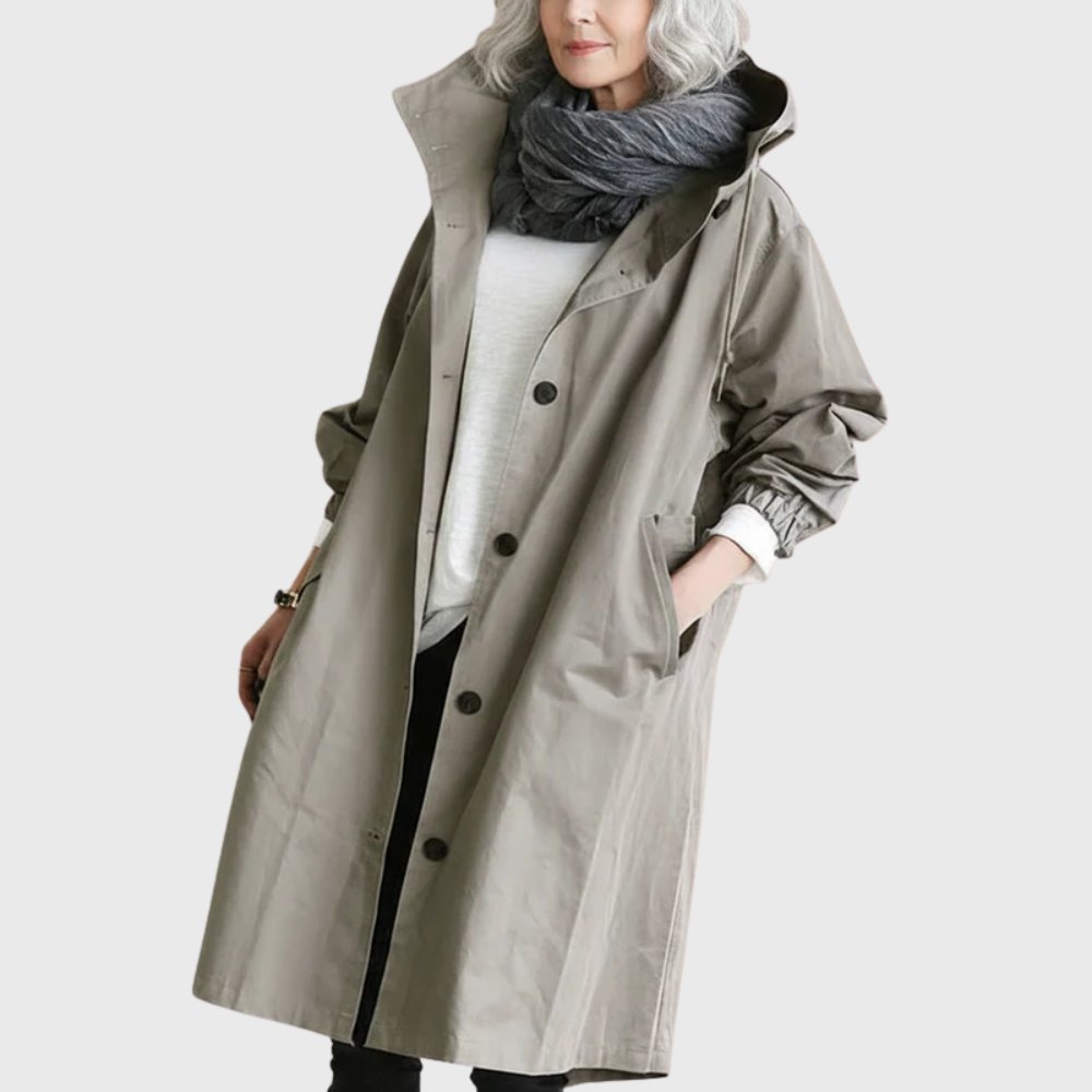 Women's waterproof hooded long trench coat by Christine Brewer, relaxed fit, perfect for rainy weather and casual outdoor wear.