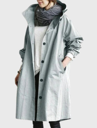 Women’s hooded waterproof long trench coat by Christine Brewer, relaxed-fit, with a hood and classic trench design.