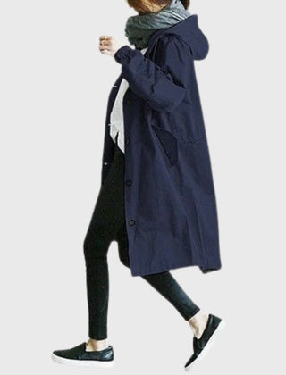 Women's waterproof hooded trench coat with relaxed fit, long length, and classic design by Christine Brewer.