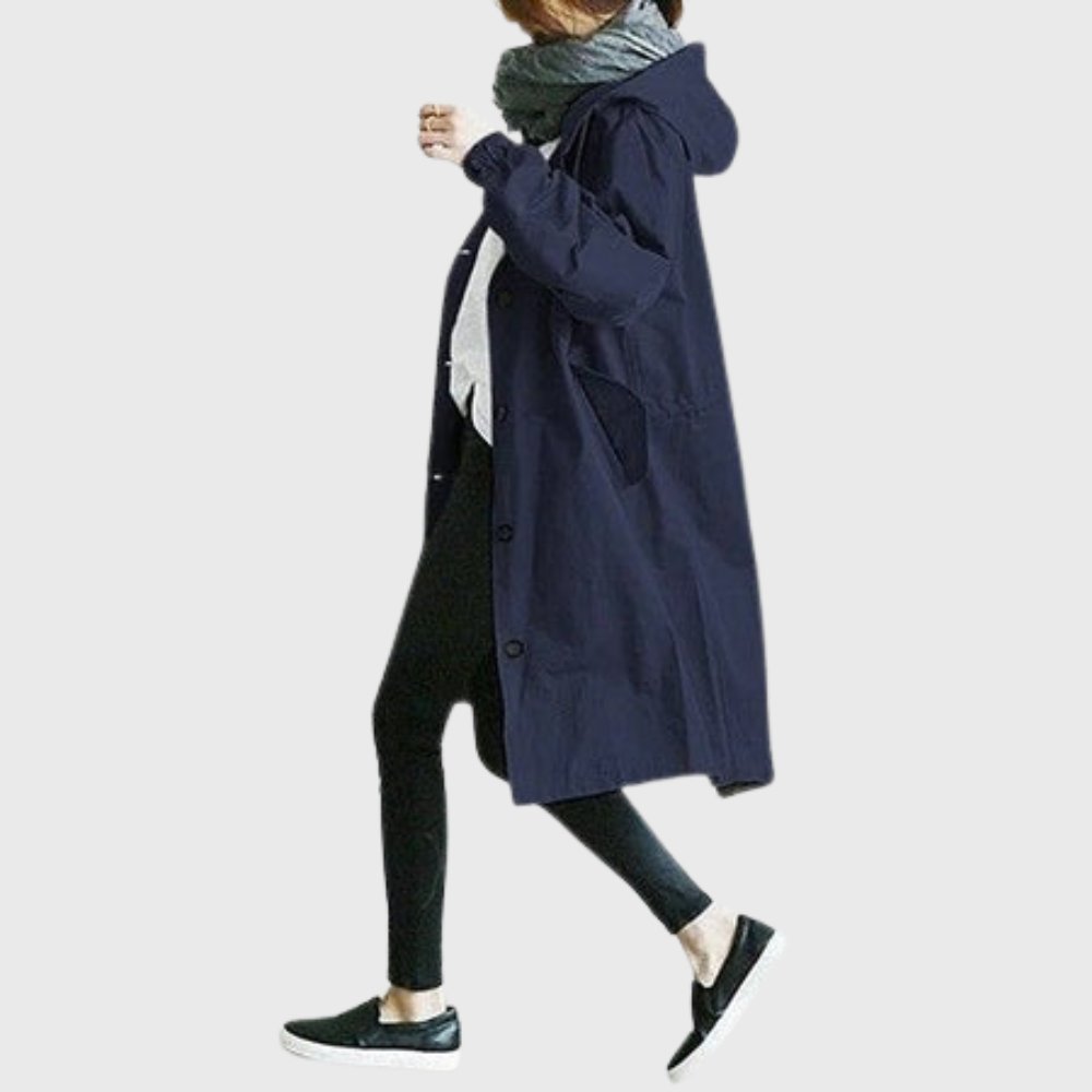 Women's waterproof hooded trench coat with relaxed fit, long length, and classic design by Christine Brewer.