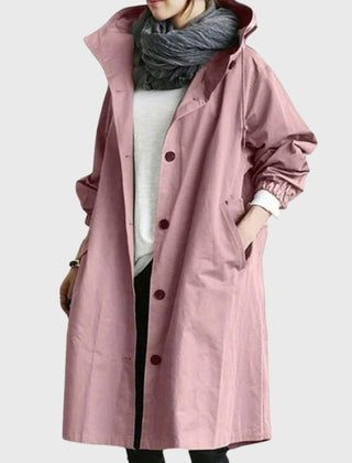 Women’s waterproof hooded long trench coat by Christine Brewer, relaxed fit with a hood, suitable for rainy weather.