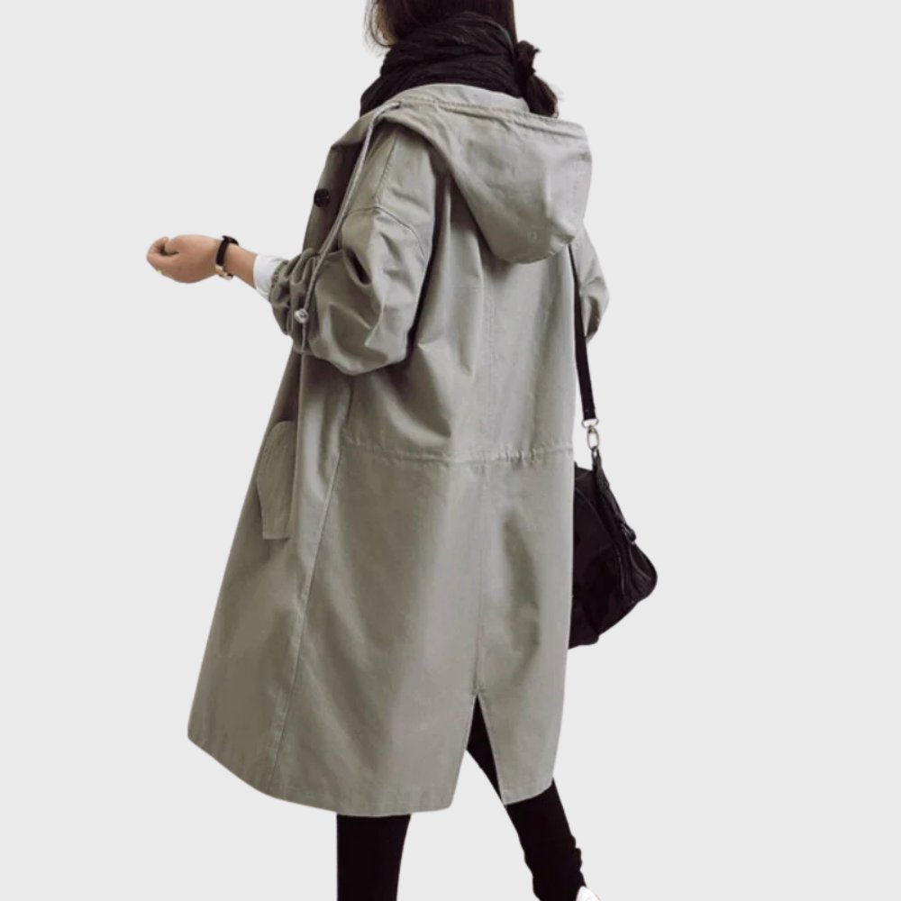Women’s waterproof hooded trench coat with relaxed fit, long length, and classic design by Christine Brewer.