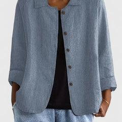 Lightweight women's cotton button-up jacket named Sophie by Christine Brewer, shown in a stylish, casual outdoor setting.