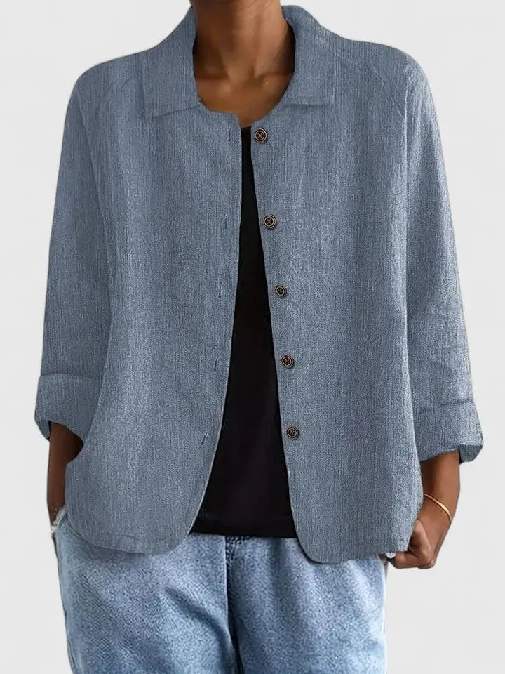Lightweight women's cotton button-up jacket named Sophie by Christine Brewer, shown in a stylish, casual outdoor setting.