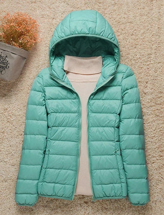 Women's Sienna lightweight hooded quilted jacket by Christine Brewer, showing the packable down puffer design with a hood and quilted texture.