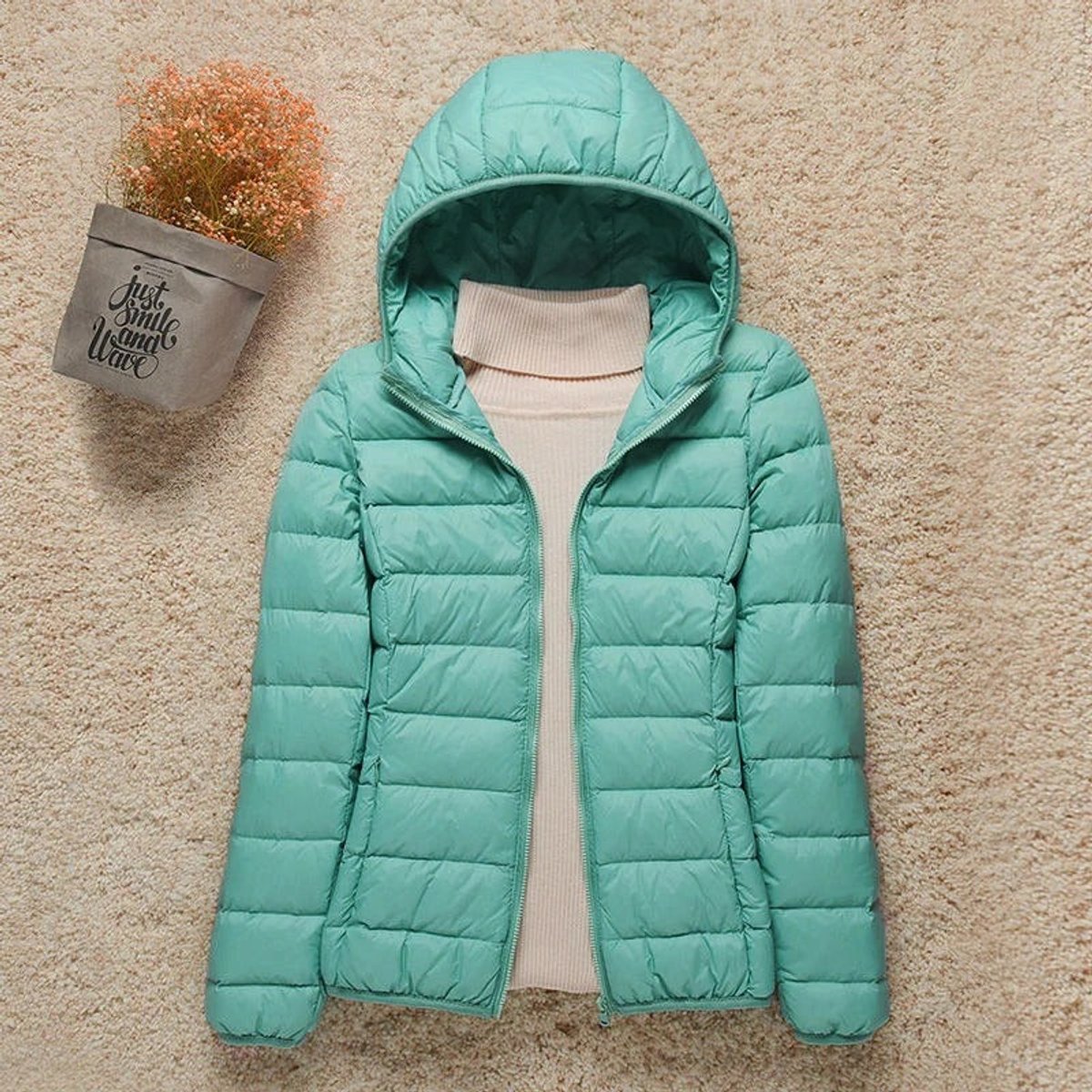 Women's Sienna lightweight hooded quilted jacket by Christine Brewer, showing the packable down puffer design with a hood and quilted texture.