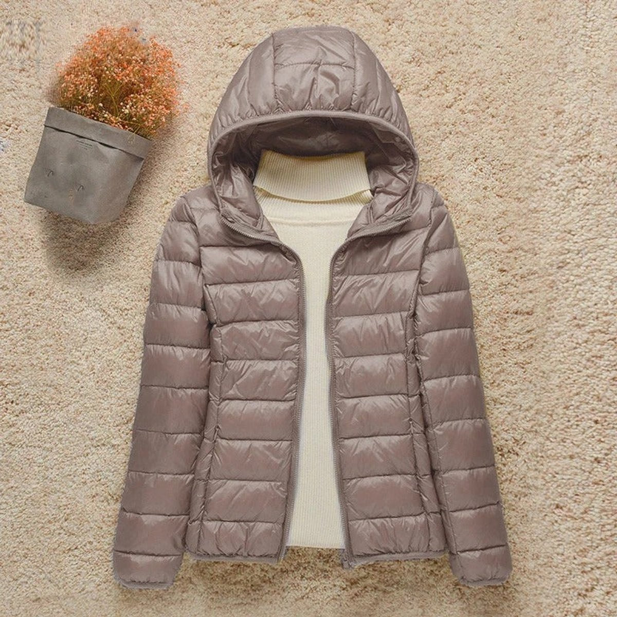Women's lightweight hooded quilted jacket by Christine Brewer, packable puffer with a cozy hood and stylish quilting details.