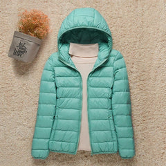 Women's lightweight hooded quilted puffer jacket by Christine Brewer, packable and stylish for cool weather.