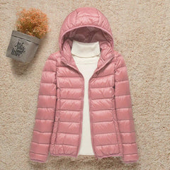 Women's lightweight hooded quilted puffer jacket by Christine Brewer, packable and ideal for casual outdoor wear.